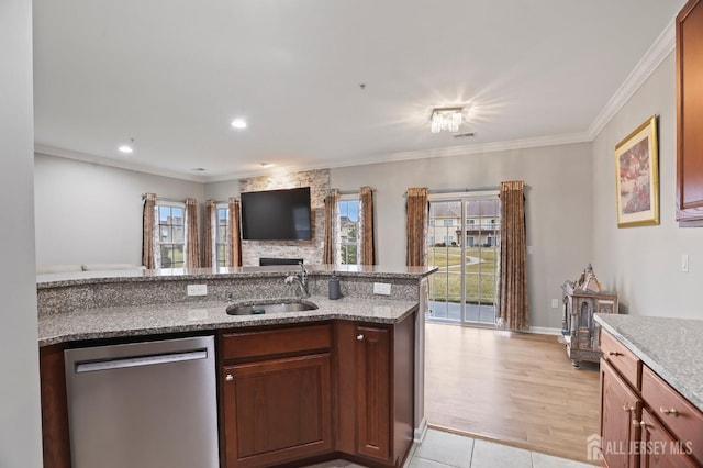 kitchen featuring stone counters, dishwasher, sink, ornamental molding, and light tile patterned floors