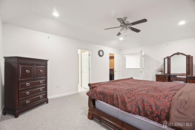 bedroom with a walk in closet, light carpet, and ceiling fan