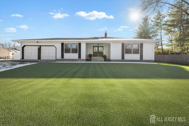 single story home with covered porch, a garage, and a front yard