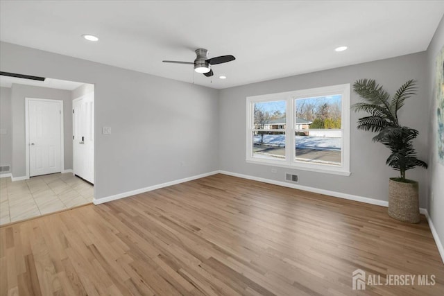 empty room with light hardwood / wood-style floors and ceiling fan