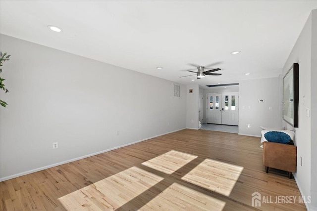 unfurnished living room with ceiling fan and hardwood / wood-style flooring