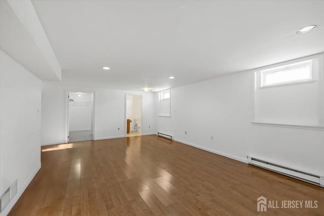 interior space with hardwood / wood-style floors and baseboard heating