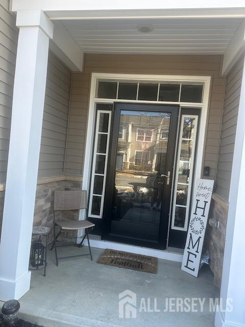 138 N Grabowski Dr Unit 1490, Sayreville, NJ 08859 - view of exterior entry featuring stone siding
