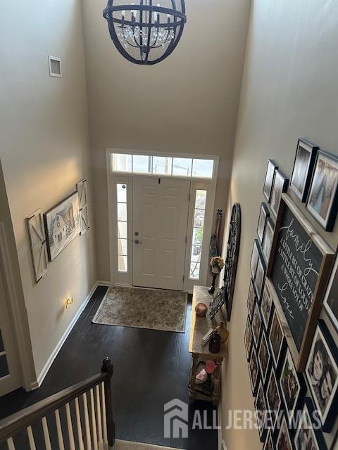 138 N Grabowski Dr Unit 1490, Sayreville, NJ 08859 - foyer with a towering ceiling, a chandelier, and wood finished floors