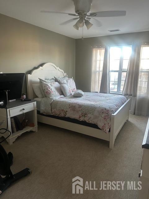 138 N Grabowski Dr Unit 1490, Sayreville, NJ 08859 - bedroom featuring light carpet and ceiling fan