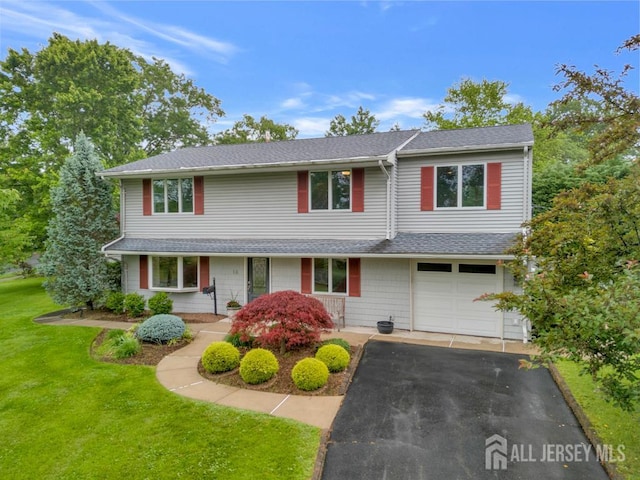 16 Russet Rd, South Brunswick, NJ 08824 - traditional-style home featuring driveway, a front yard, a garage, and a shingled roof