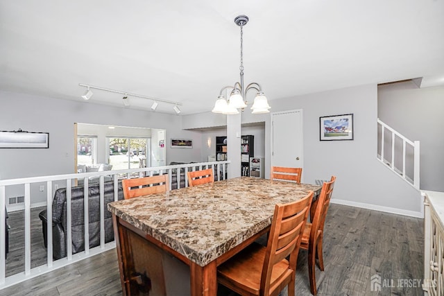 dining room featuring an inviting chandelier, dark wood-style flooring, baseboards, and visible vents