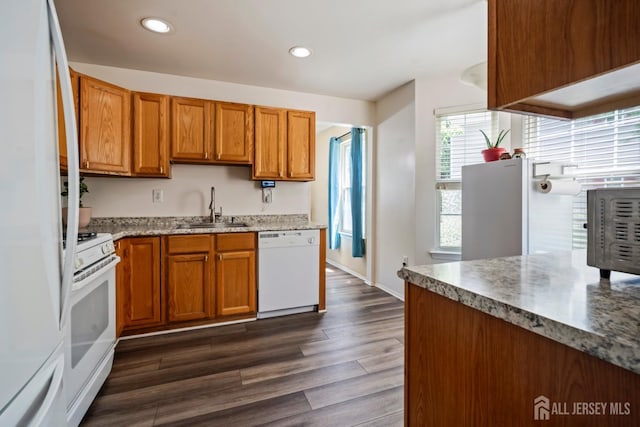 1301 Cypress Ln, East Brunswick, NJ 08816 - kitchen with white appliances, brown cabinetry, dark wood-style flooring, recessed lighting, and light stone countertops