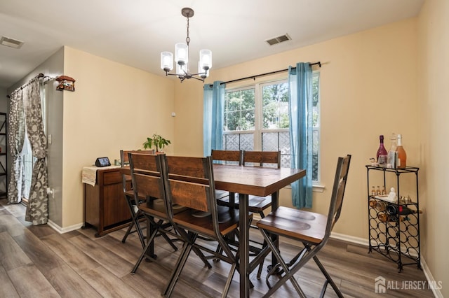 1301 Cypress Ln, East Brunswick, NJ 08816 - dining space featuring wood finished floors and a chandelier