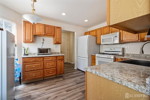 1301 Cypress Ln, East Brunswick, NJ 08816 - kitchen featuring white appliances, light wood-type flooring, recessed lighting, decorative light fixtures, and light stone countertops