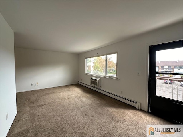 unfurnished room featuring a baseboard heating unit, carpet flooring, and baseboards