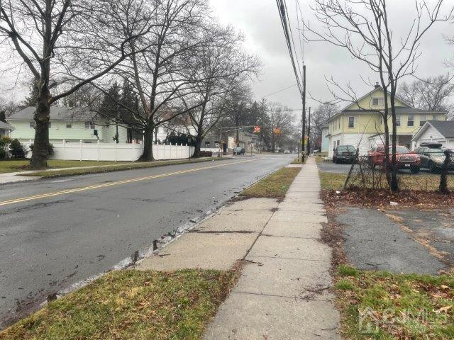 view of road featuring a residential view and sidewalks