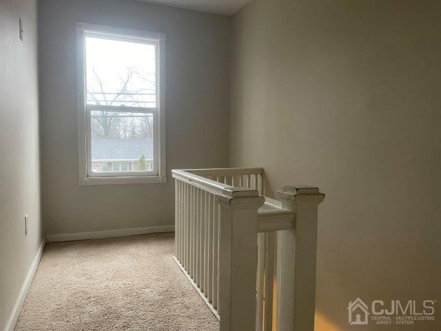 interior space featuring carpet floors and baseboards