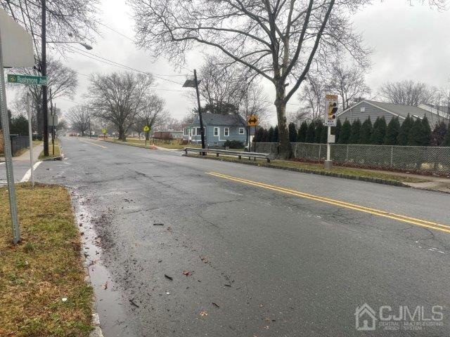 view of street featuring curbs, traffic signs, sidewalks, and a residential view