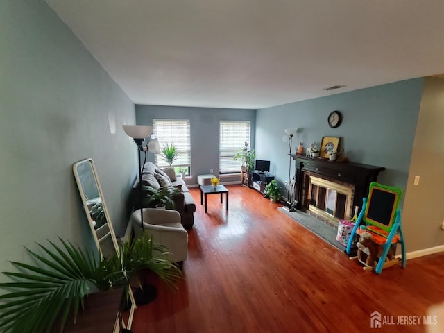 323 Gill Ln Unit 12Q, Iselin, NJ 08830 - living room featuring wood finished floors and a glass covered fireplace