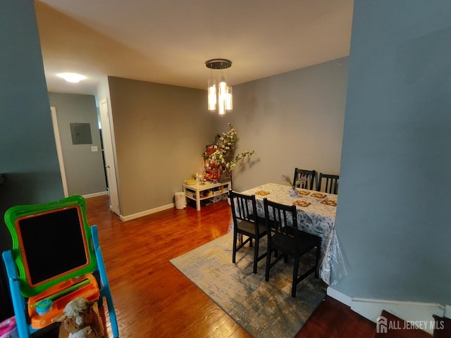 323 Gill Ln Unit 12Q, Iselin, NJ 08830 - dining area with wood finished floors, a chandelier, and electric panel