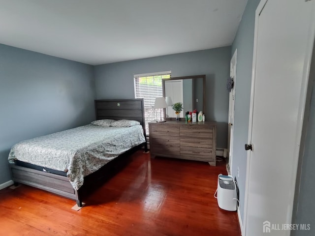 323 Gill Ln Unit 12Q, Iselin, NJ 08830 - bedroom with wood finished floors and a baseboard radiator