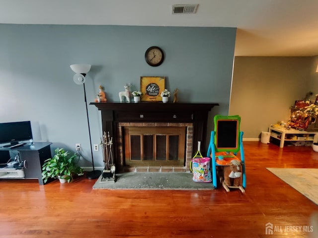 323 Gill Ln Unit 12Q, Iselin, NJ 08830 - living room featuring a glass covered fireplace and wood finished floors