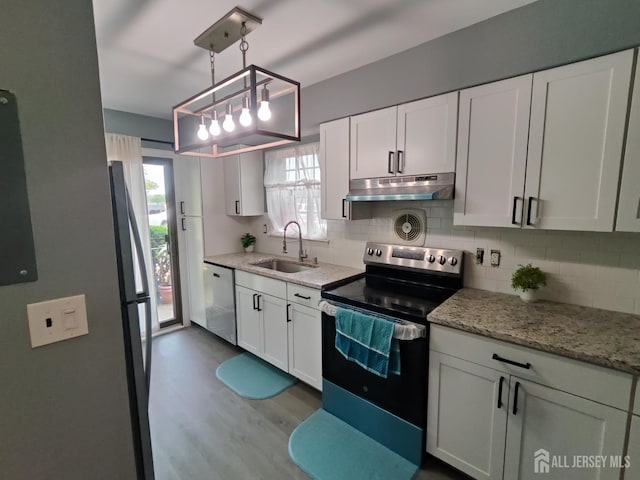 323 Gill Ln Unit 12Q, Iselin, NJ 08830 - kitchen featuring appliances with stainless steel finishes, under cabinet range hood, tasteful backsplash, and dark wood-style floors