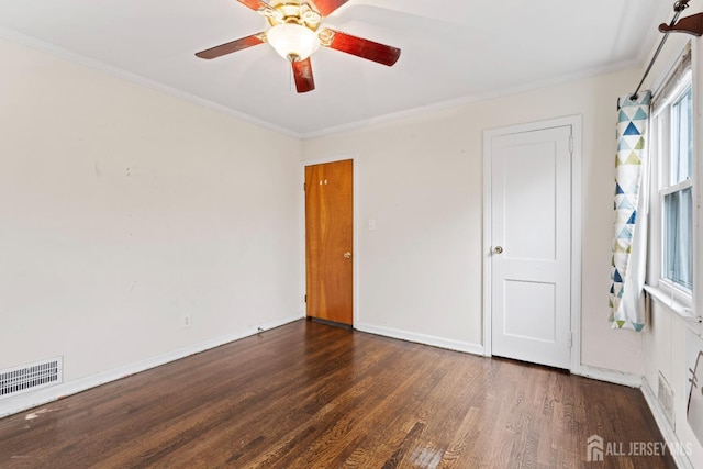 unfurnished bedroom featuring wood finished floors, crown molding, baseboards, and ceiling fan