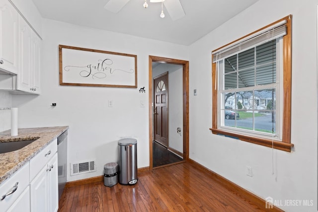 505 Lorraine Ave, Middlesex, NJ 08846 - kitchen featuring dark wood-style floors, white cabinets, baseboards, and light stone counters