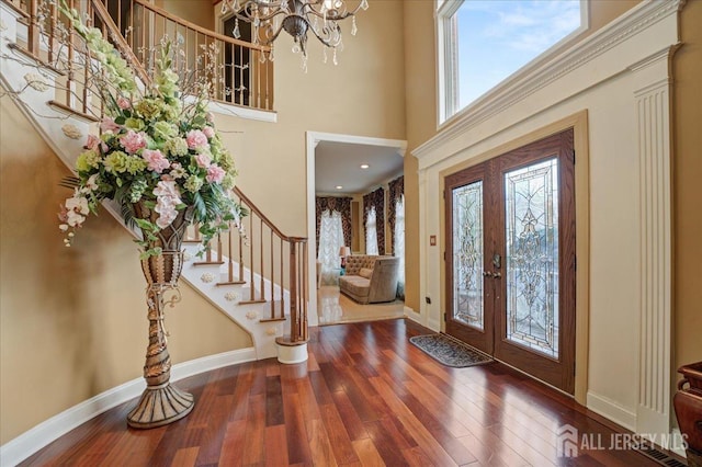 6 Lexington Ct, Monroe, NJ 08831 - foyer entrance featuring stairway, a high ceiling, a chandelier, wood finished floors, and baseboards