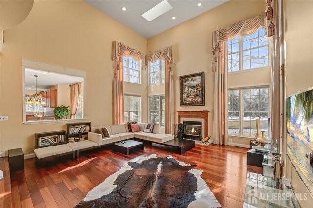 6 Lexington Ct, Monroe, NJ 08831 - living area featuring a high ceiling, wood-type flooring, plenty of natural light, a glass covered fireplace, and recessed lighting