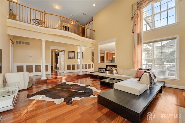 6 Lexington Ct, Monroe, NJ 08831 - living room with a towering ceiling, wood finished floors, and decorative columns