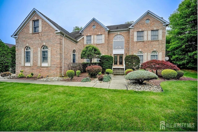 6 Lexington Ct, Monroe, NJ 08831 - georgian-style home with a front yard, french doors, and brick siding