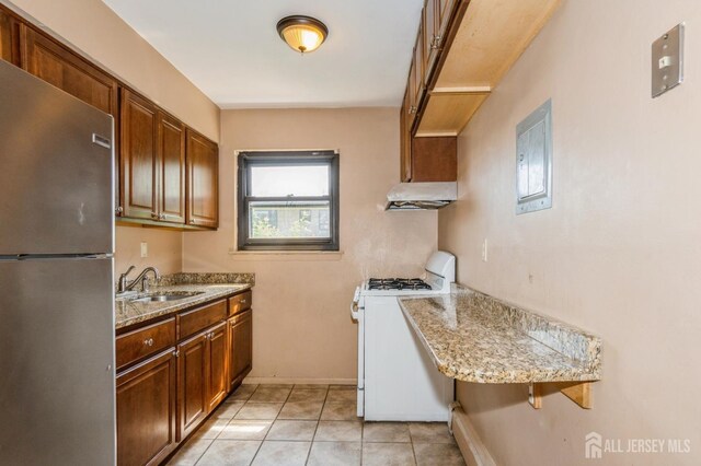 401 US Highway 22nd Rd Unit B8U1, North Plainfield, NJ 07060 - kitchen featuring freestanding refrigerator, gas range gas stove, under cabinet range hood, and light stone countertops