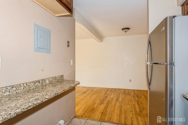 401 US Highway 22nd Rd Unit B8U1, North Plainfield, NJ 07060 - kitchen with freestanding refrigerator, electric panel, light stone counters, and light wood-style floors