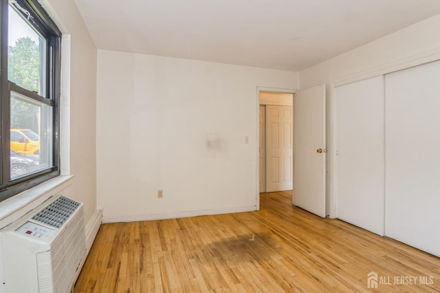 401 US Highway 22nd Rd Unit B8U1, North Plainfield, NJ 07060 - unfurnished bedroom with light wood finished floors, a closet, and a wall mounted air conditioner