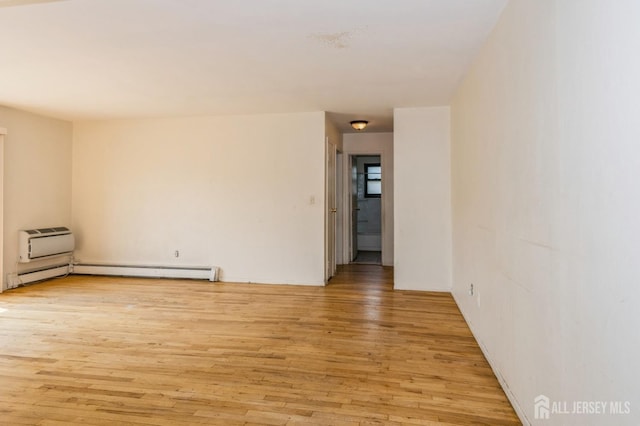 401 US Highway 22nd Rd Unit B8U1, North Plainfield, NJ 07060 - spare room featuring light wood-style flooring, a baseboard radiator, and a wall mounted AC