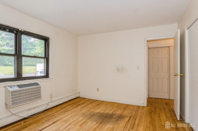 401 US Highway 22nd Rd Unit B8U1, North Plainfield, NJ 07060 - spare room featuring a baseboard radiator, an AC wall unit, and light wood finished floors
