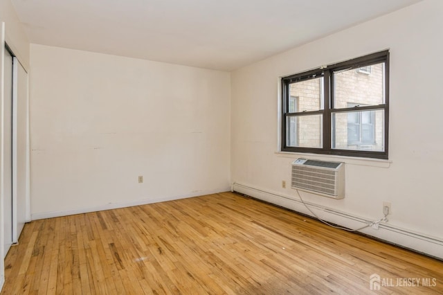 401 US Highway 22nd Rd Unit B8U1, North Plainfield, NJ 07060 - unfurnished bedroom featuring baseboard heating, an AC wall unit, and light wood-style floors