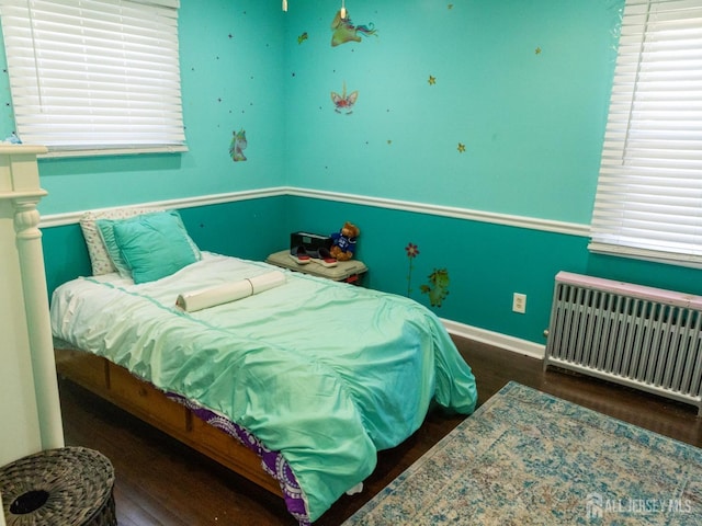 237 Cook Ave, Middlesex, NJ 08846 - bedroom with baseboards, radiator heating unit, multiple windows, and wood finished floors