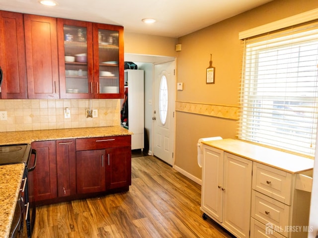 237 Cook Ave, Middlesex, NJ 08846 - kitchen with dark brown cabinets, dark wood finished floors, tasteful backsplash, glass insert cabinets, and black range with electric stovetop