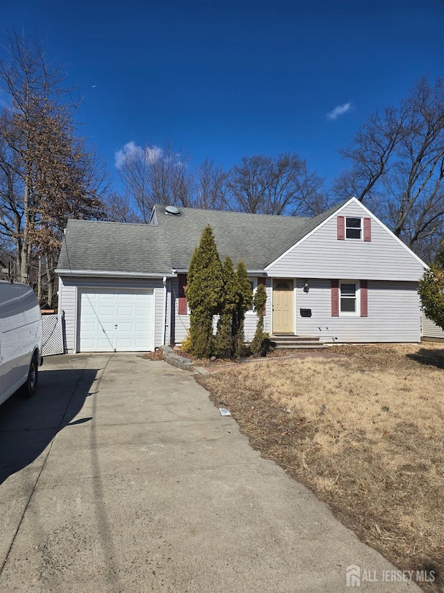 view of front of property with a shingled roof, concrete driveway, and an attached garage