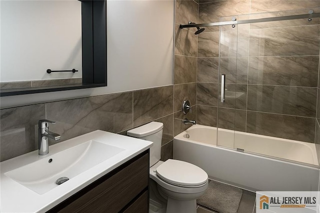 344 Danbury Ln Unit 344, East Brunswick, NJ 08816 - bathroom with tile walls, combined bath / shower with glass door, vanity, and a wainscoted wall