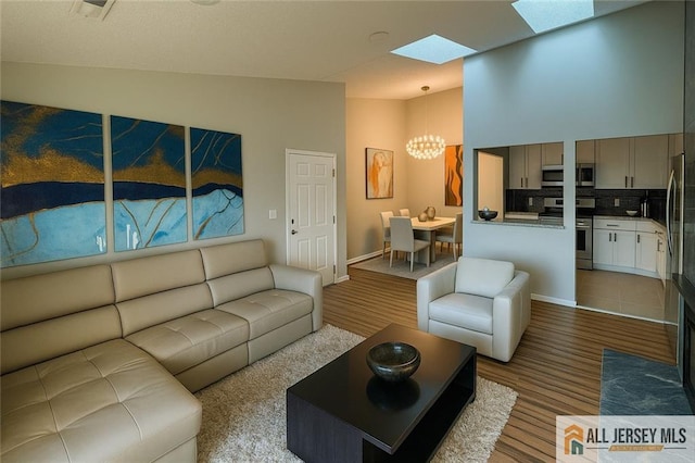 344 Danbury Ln Unit 344, East Brunswick, NJ 08816 - living area featuring a skylight and a chandelier