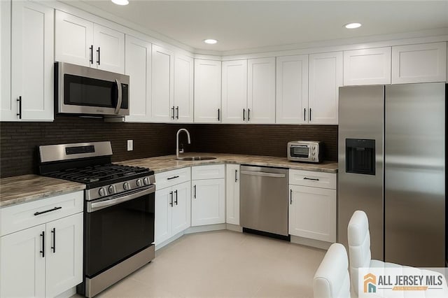 344 Danbury Ln Unit 344, East Brunswick, NJ 08816 - kitchen with appliances with stainless steel finishes, white cabinetry, backsplash, recessed lighting, and light stone countertops
