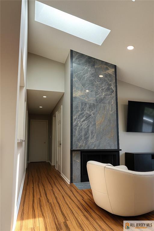 344 Danbury Ln Unit 344, East Brunswick, NJ 08816 - hallway with a skylight, wood finished floors, recessed lighting, and vaulted ceiling