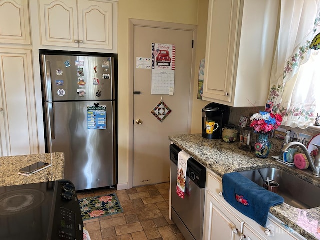 88 Lowell St Unit B, Carteret, NJ 07008 - kitchen featuring stainless steel appliances, cream cabinetry, stone finish flooring, and light stone countertops