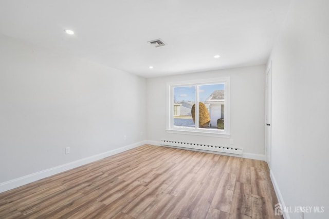187 Newport Rd Unit A, Monroe, NJ 08831 - spare room featuring a baseboard radiator, wood finished floors, baseboards, and recessed lighting