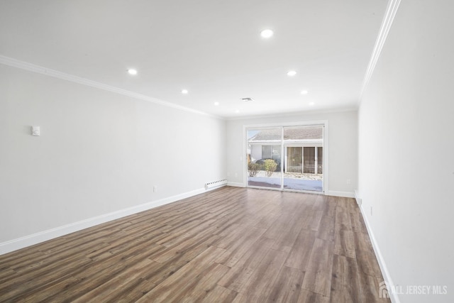 unfurnished living room with hardwood / wood-style flooring, ornamental molding, and a baseboard heating unit