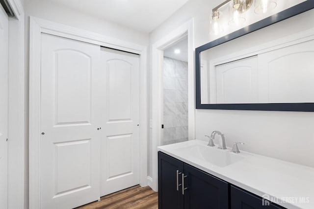 bathroom with hardwood / wood-style floors and vanity