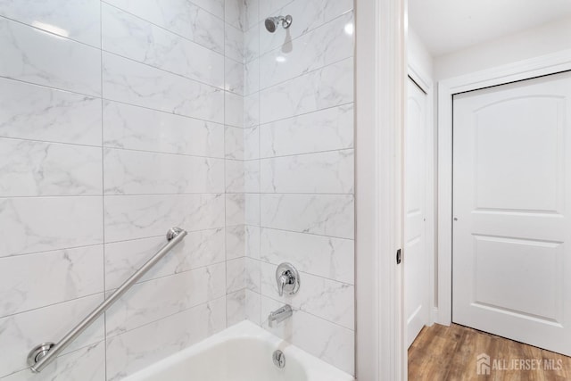 bathroom featuring hardwood / wood-style floors and tiled shower / bath combo