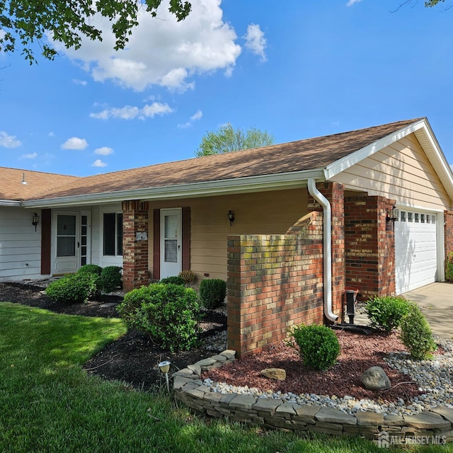 187 Newport Rd Unit A, Monroe, NJ 08831 - ranch-style house featuring brick siding, an attached garage, concrete driveway, a shingled roof, and covered porch