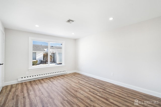 187 Newport Rd Unit A, Monroe, NJ 08831 - empty room with baseboard heating, wood finished floors, baseboards, and recessed lighting