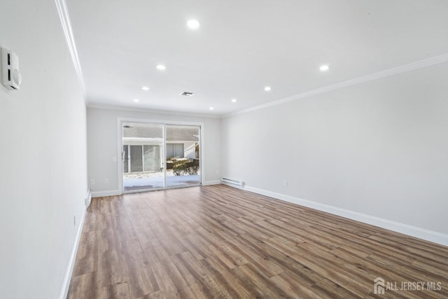 unfurnished living room with hardwood / wood-style floors, a baseboard radiator, and ornamental molding